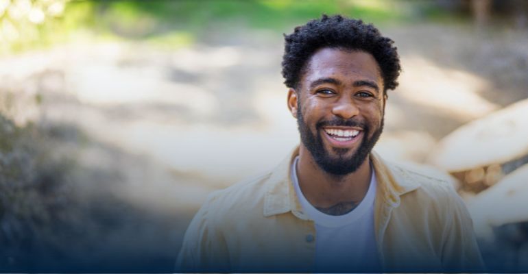 A young man smiling at the camera 