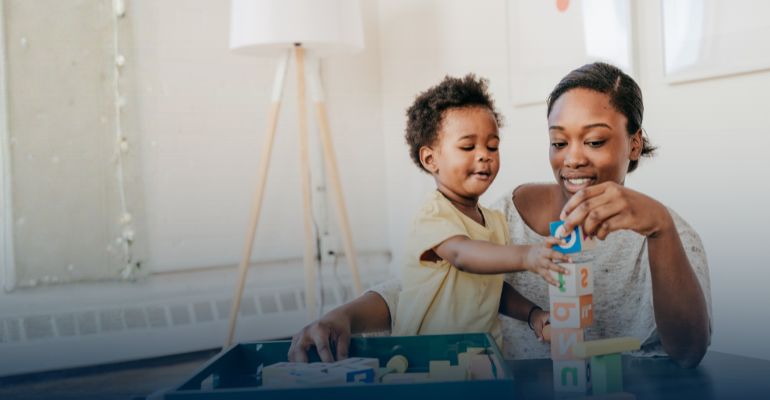 A mom and toddler playing with blocks