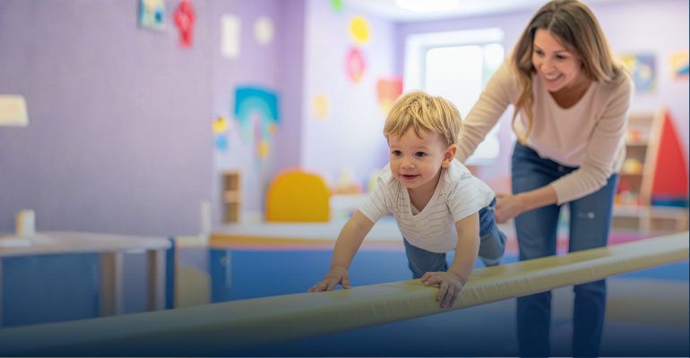 Little boy crawling across balance beam