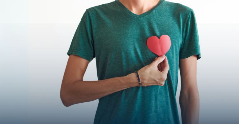 Man holding a paper heart cut out