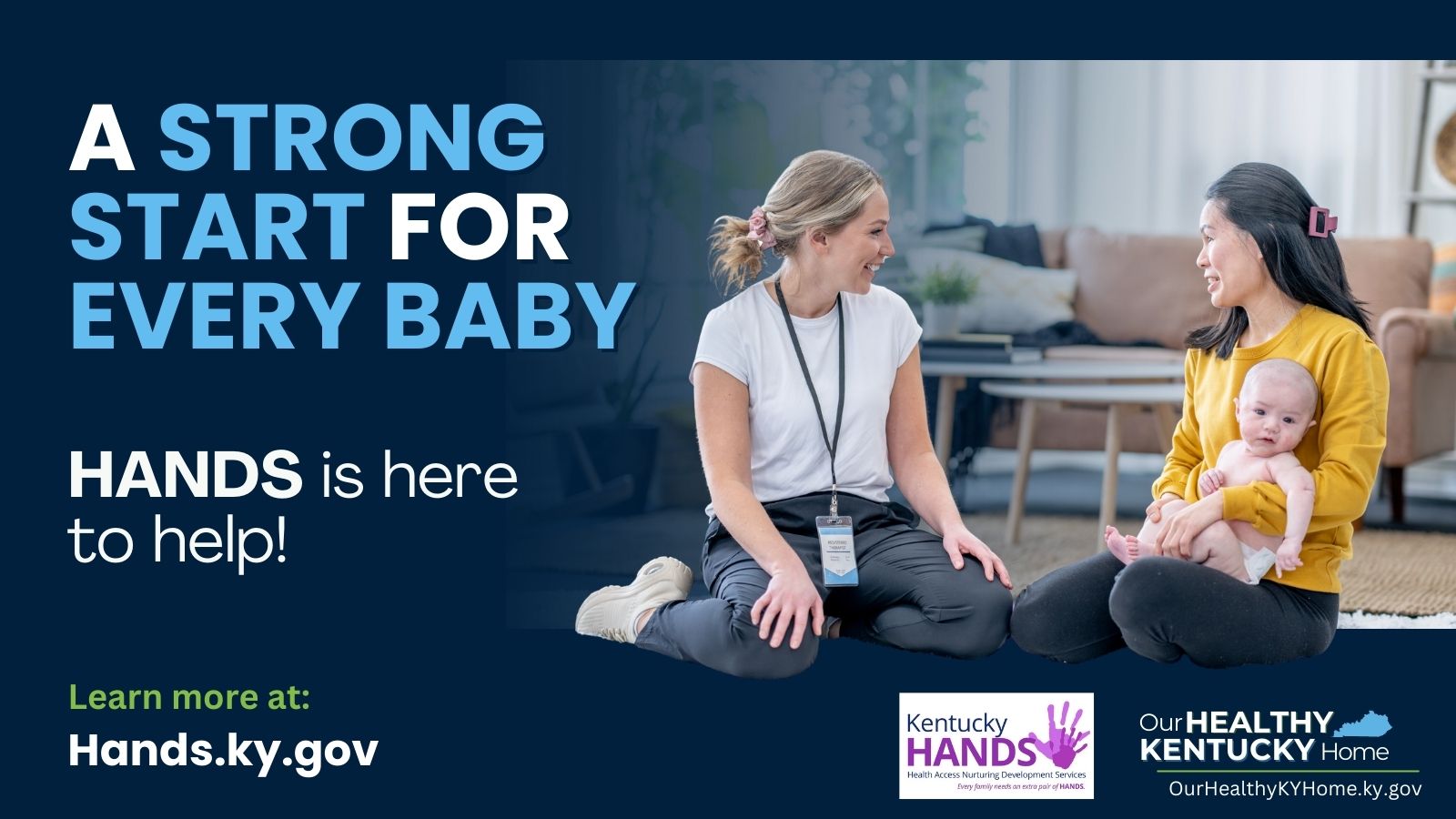 Two women sitting on a floor one holding a baby
